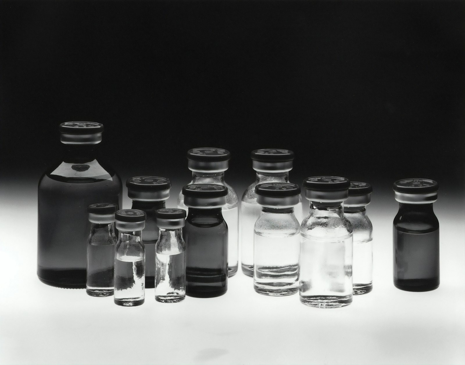 Clear glass vials in black and white